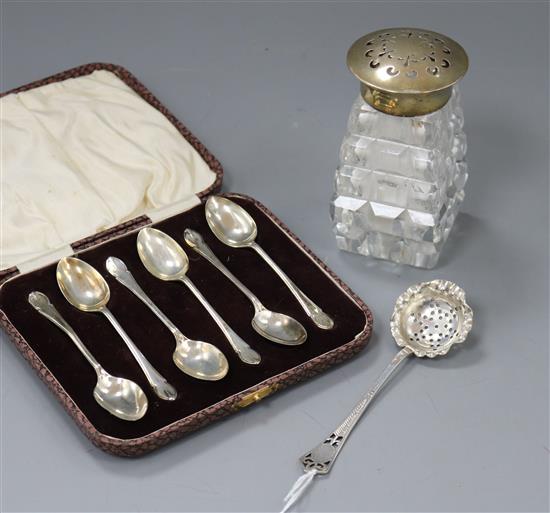 A silver topped bottle , caster and spoons.